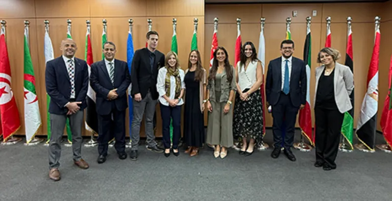 people standing in front of flags for a photo