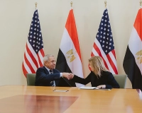 people standing in front of flags for a photo