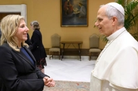 woman with blond hair in a black dress suit conversing with the Pope President Lori Meets Pope Leo XIV