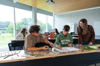 three students in education classroom
