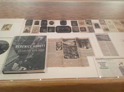 newspaper clippings and book about berenice abbott laid out on table