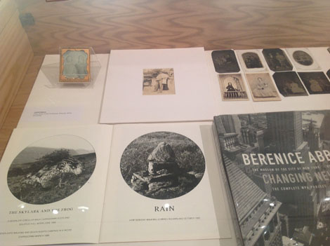 newspaper clippings and book about berenice abbott laid out on table