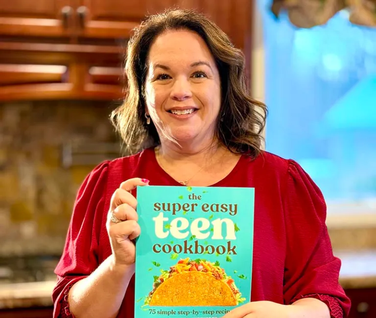 a lady holding a cookbook