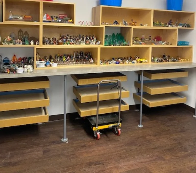 sandtrays with figurines in shelves