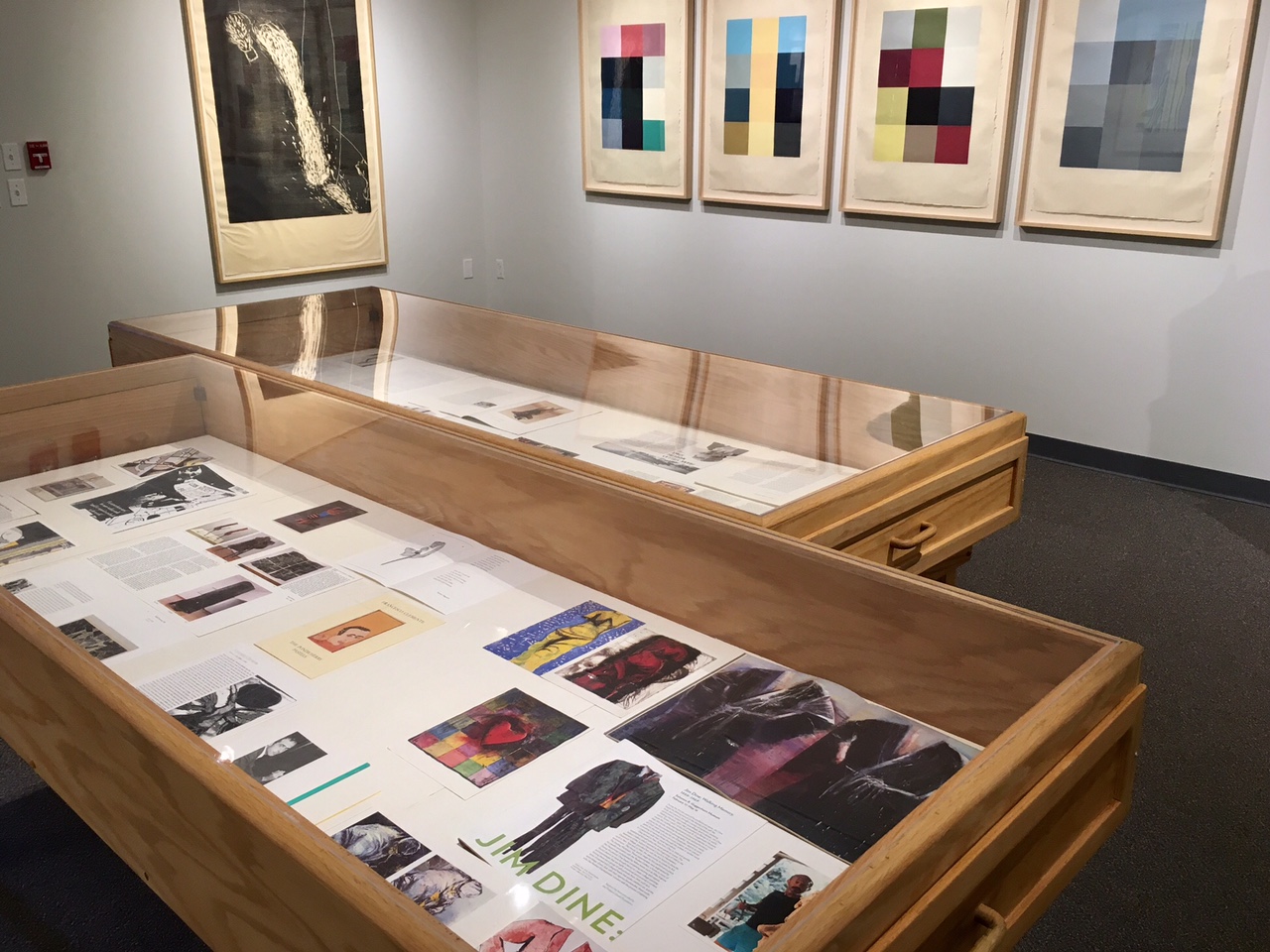 large shadow box tables with artwork displayed and framed artwork on walls