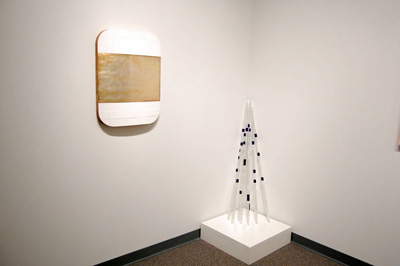 artwork on wall next to statue