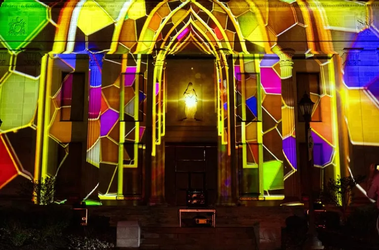 Multi-colored stained glass 3D lighting projection art on the front of the Liberal Arts Center