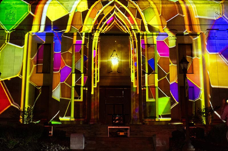 Multi-colored stained glass 3D lighting projection art on the front of the Liberal Arts Center