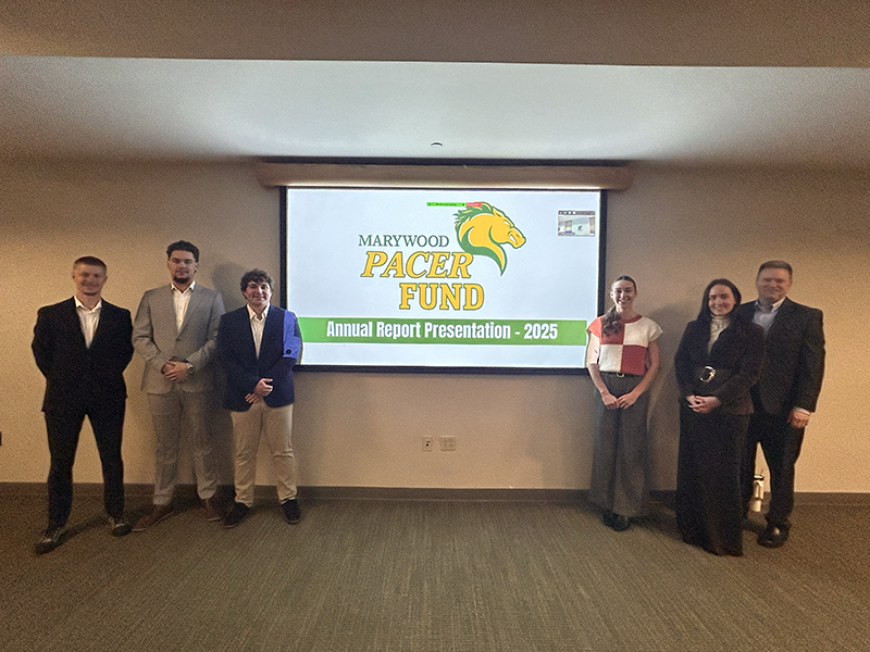 people standing in front of a screen that says pacer fund