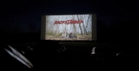 dark enviornment with a screen with the word backstabber on it