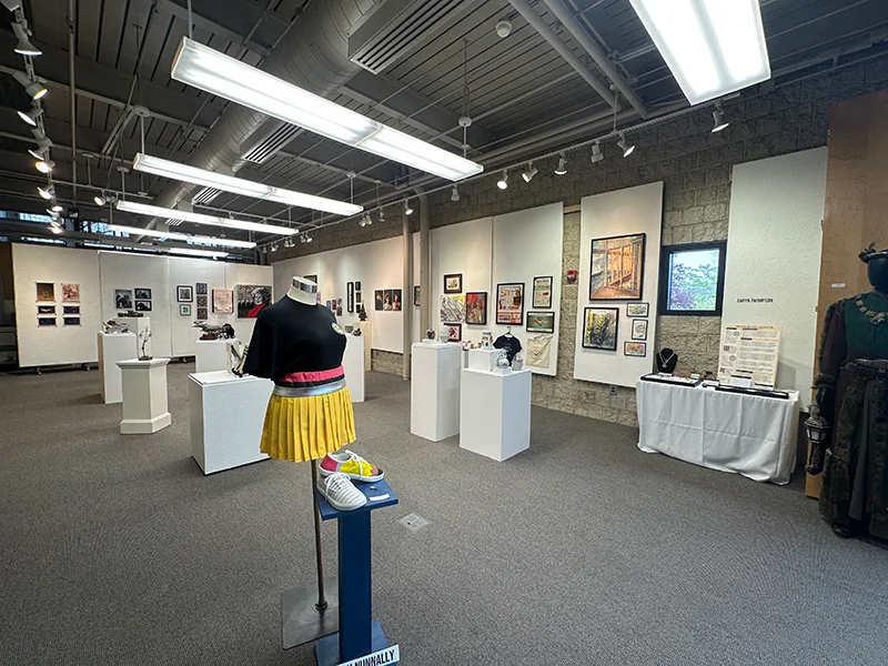 White walls of the Kresge Gallery with pieces of art on them