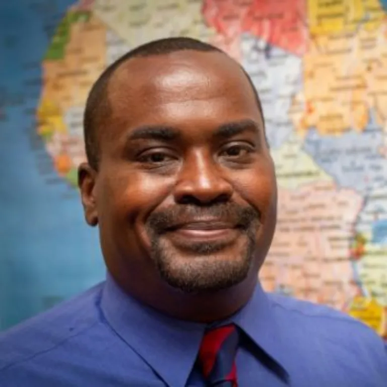 headshot with a map behind it