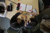 Bird's eye view of two education students sitting at a table. Students rearrange small children's toys on the table Nurturing Young Minds: The Joys of Teaching PK-4 at Marywood University