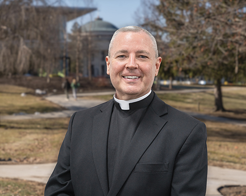 a headshot of Father Thomas