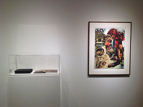 framed artwork on wall next to display case