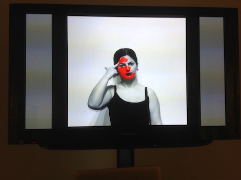 video of woman with red paint on face